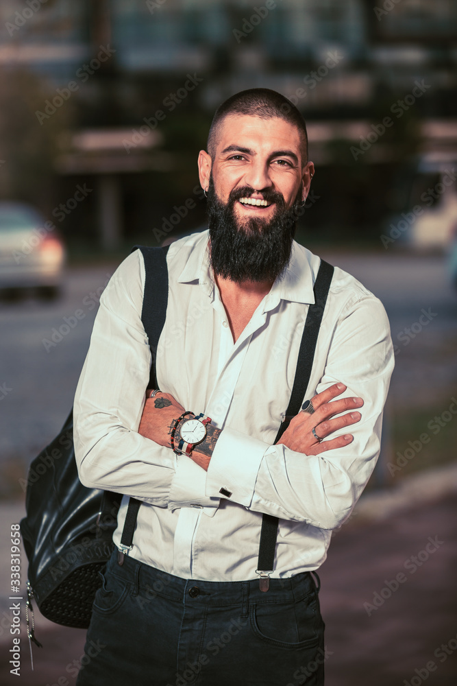 Bearded hipster businessman standing outdoor in office building background Bearded hipster businessman standing outdoor in office building background