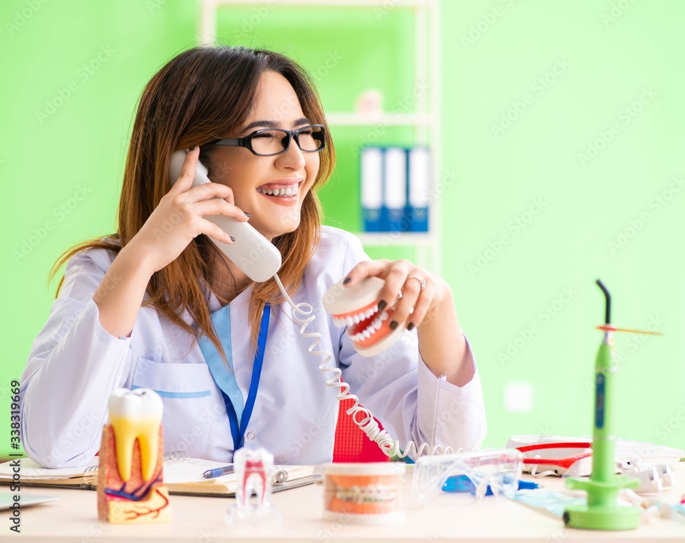 Woman dentist working on teeth implant Woman dentist working on teeth implant
