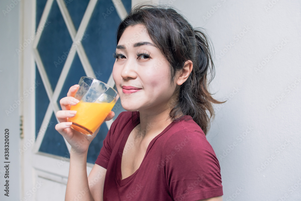 A healthy woman drinking orange juice A healthy woman drinking orange juice