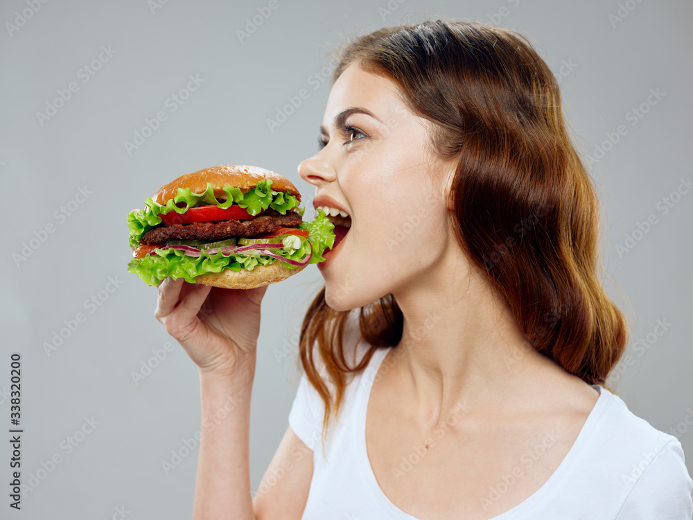young woman eating a sandwich