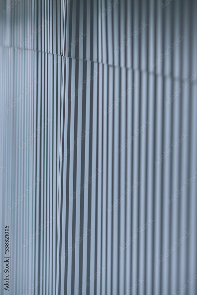 Fototapeta premium Abstract background, a fence of metal sheets. Metal rolling, metal profile, blurred texture with copy space.
