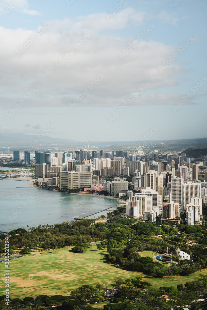 Dramatic views of Waikiki from the Diamond Head Crater Hike summit on a bright but cloudy day.