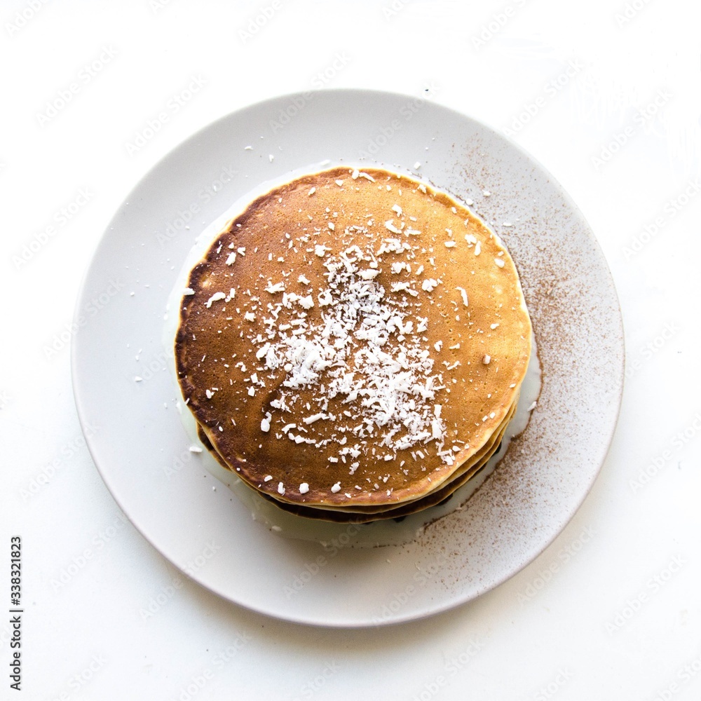 Fried pancakes with coconut flakes and sweet sauce Fried pancakes with coconut flakes and sweet sauce