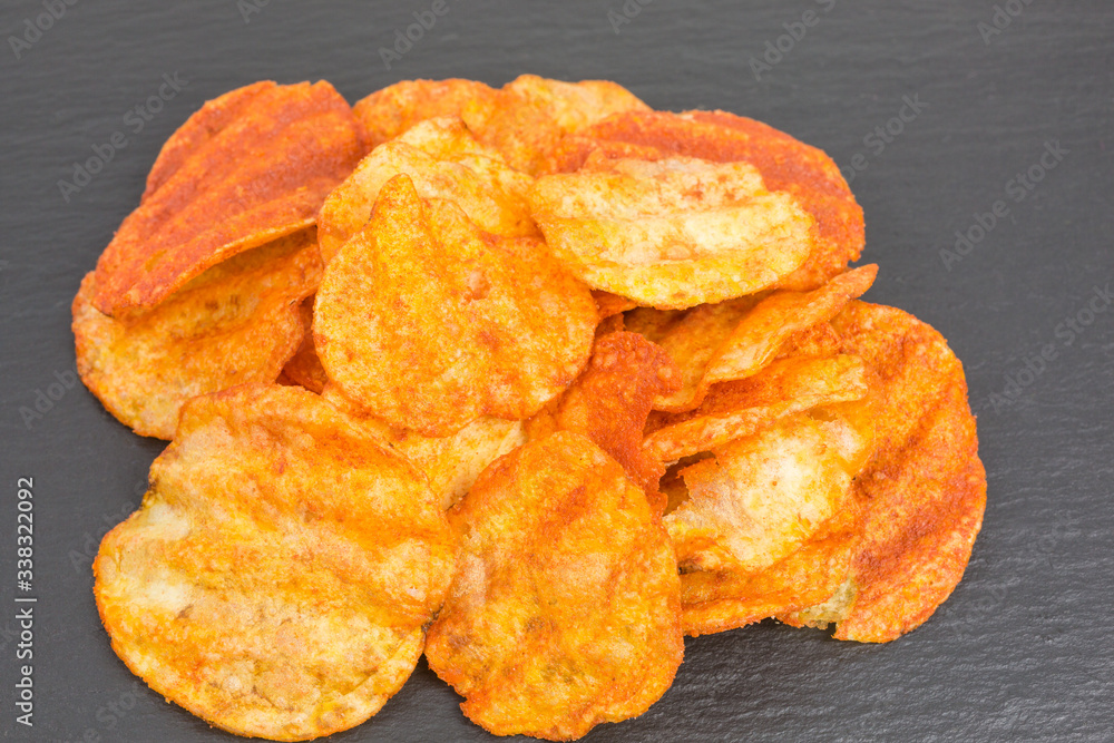 heap of potato crisps snack with paprika and sour cream flavor heap of potato crisps snack with paprika and sour cream flavor