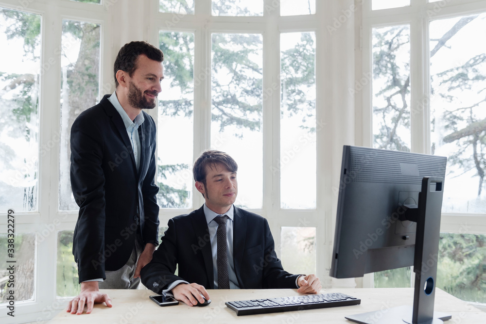 Two male executive working with computers