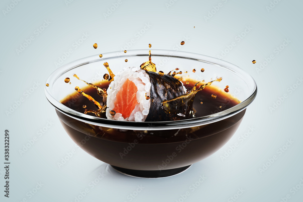 Sushi maki drops in a bowl with soy sauce on light background. Splash of  soy sauce. Photos | Adobe Stock
