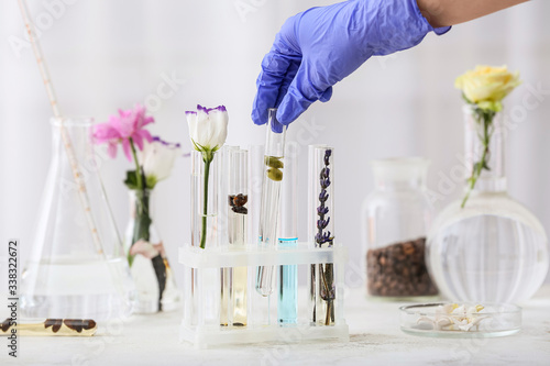 Woman preparing perfume on table photo