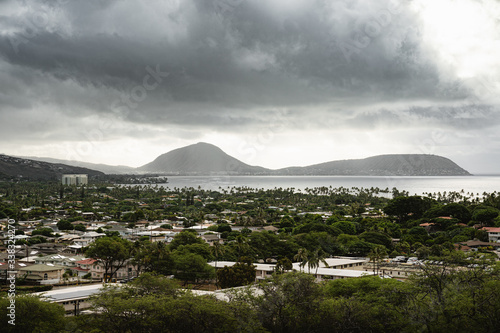 Moody views of clouds hanging over Waialae - Kahala, taken from the Kahala Lookout at Diamond Head Crater. photo