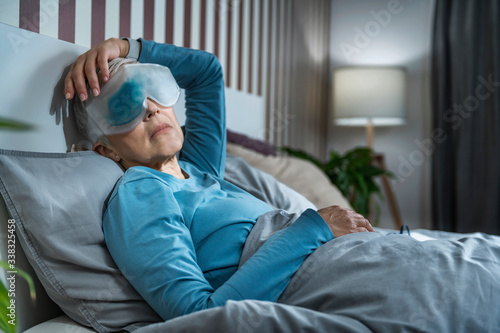 Mature Woman Wearing Cooling Blue Gel Eye Mask Against Dark Circles