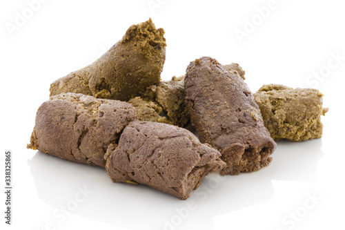 Dog shit. Pile of dog excrements on white bg. Isolated on white background with shadow reflection. With clipping path. With vector path. Dog feces, studio shot. Closeup shot. Cock of dog's turds. photo