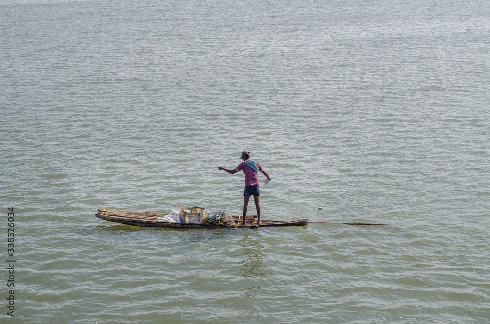 Naklejka premium fishermen busy in Fishing on a river