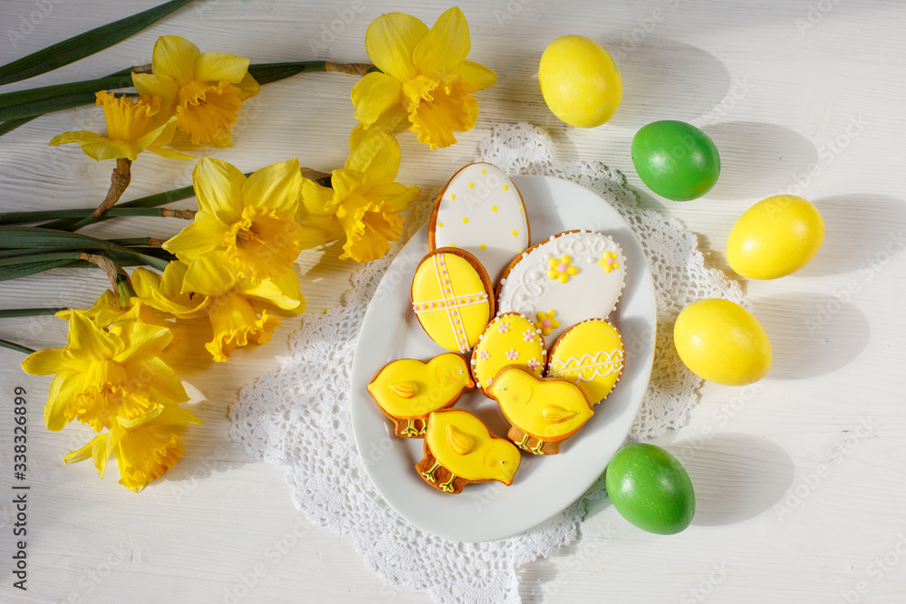 Easter table setting, decor: Easter gingerbread eggs, a bouquet of spring flowers. Beautiful morning light Easter table setting, decor: Easter gingerbread eggs, a bouquet of spring flowers. Beautiful morning light