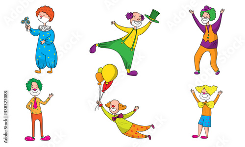 Set of positive clowns during show in colorful costumes