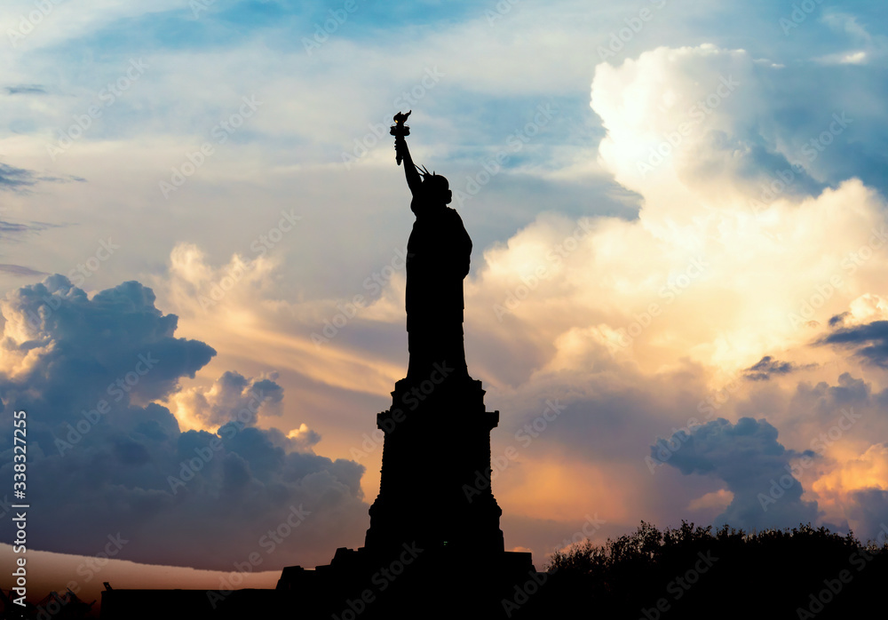 New York, USA - November 2019: Silhouette of Statue of Liberty over dramatic full moon