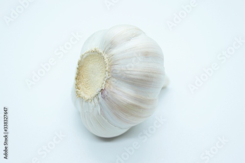 The head of ripe delicious garlic is located on a white background