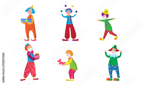 Set of positive clowns during show in colorful costumes with accessories for magic
