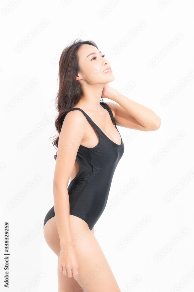 Beautiful asian woman wearing black swimming suit dress, wearing a sun hat in a summer fashion at studio shot with sunlight isolated on white background. Summer travel concept. Beautiful asian woman wearing black swimming suit dress, wearing a sun hat in a summer fashion at studio shot with sunlight isolated on white background. Summer travel concept.