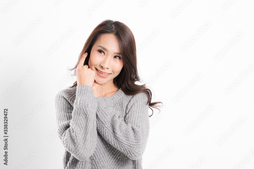 Pretty smiling joyfully being happy asian woman portrait with perfect skin and wearing a gray sweater in profile at studio shot isolated on white background. Pretty smiling joyfully being happy asian woman portrait with perfect skin and wearing a gray sweater in profile at studio shot isolated on white background.