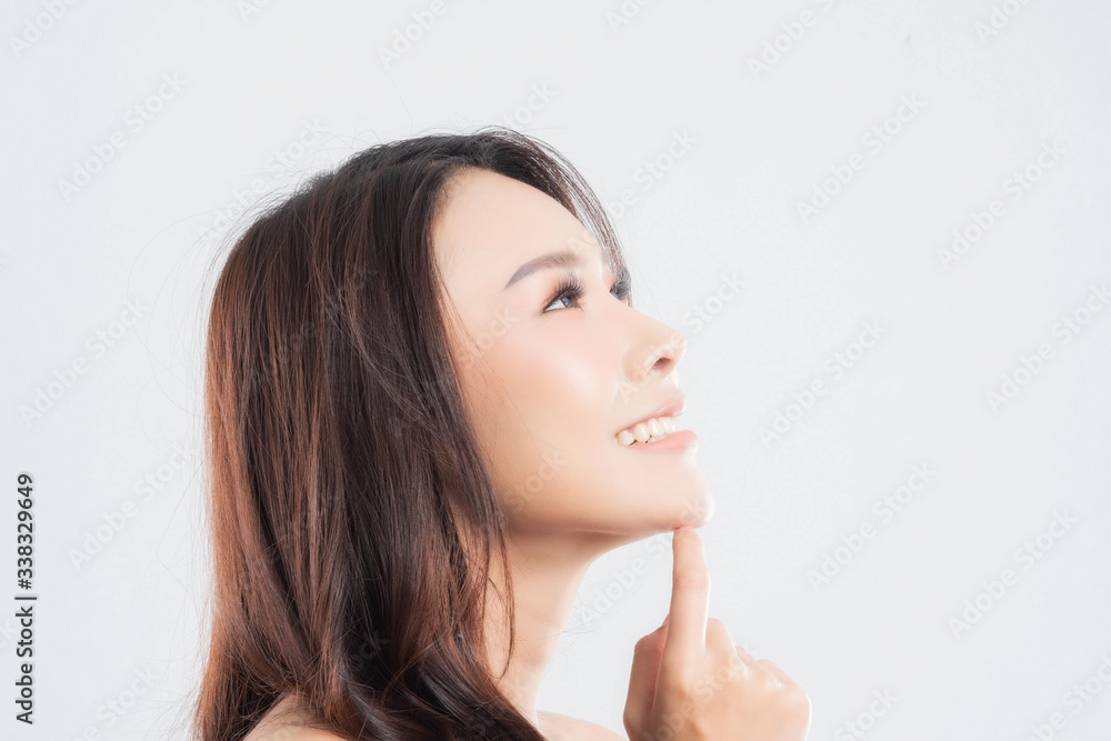 Beautiful young woman with clean fresh skin, Hair sleek, Proposing a product. Gestures for advertisement on gray background, Front view, with copy space. Beautiful young woman with clean fresh skin, Hair sleek, Proposing a product. Gestures for advertisement on gray background, Front view, with copy space.