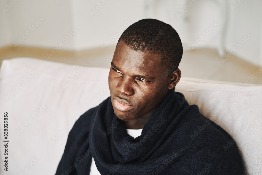 portrait of a man sitting on sofa portrait of a man sitting on sofa