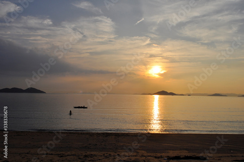 Sea kayak floating on the sea where the sunset is reflected
