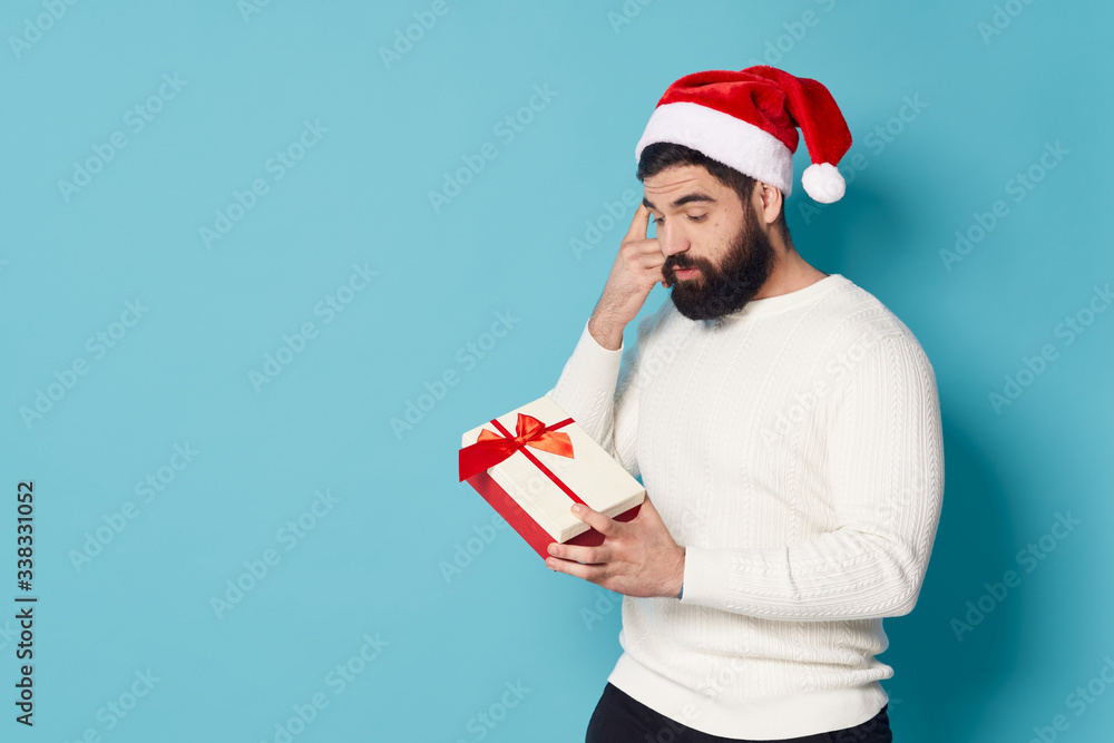 young man in santa hat with gift young man in santa hat with gift