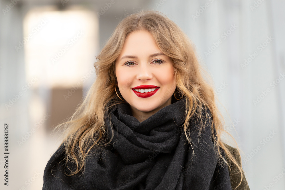Closeup portrait of a happy young woman smiling. Stylish fashion portrait woman. Posing in the city. Beautiful girl in autumn green coat and black scarf poses in an overhead pedestrian crossing. Closeup portrait of a happy young woman smiling. Stylish fashion portrait woman. Posing in the city. Beautiful girl in autumn green coat and black scarf poses in an overhead pedestrian crossing.