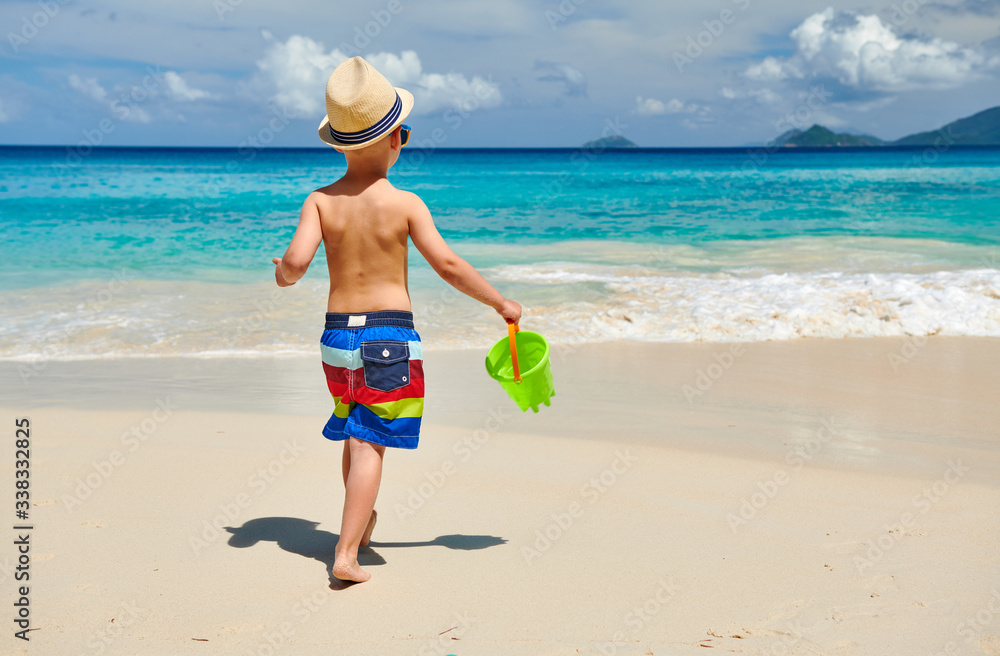 Three year old toddler playing on beach Three year old toddler playing on beach