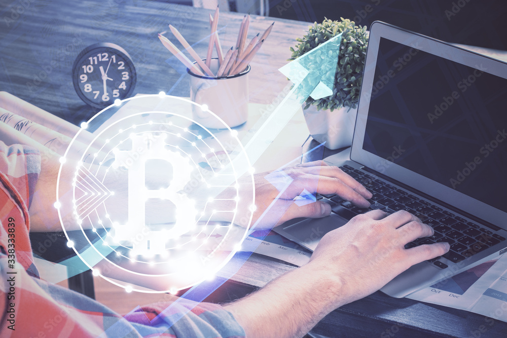 Crypto currency theme hologram with businessman working on computer on background. Concept of blockchain. Multi exposure. Crypto currency theme hologram with businessman working on computer on background. Concept of blockchain. Multi exposure.