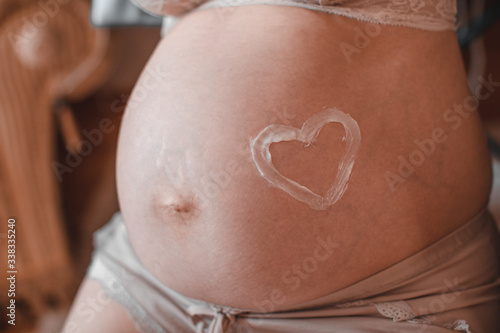 Wallpaper Mural A closeup of a pregnant woman's tummy, with a heart drawn around her belly button. Torontodigital.ca