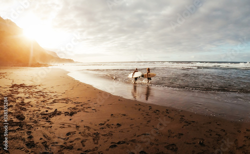 Photography Happy friends surfing together on tropical ocean - Sporty people having fun duri