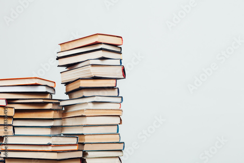lots of stacks of educational books to teach in the library on a white background photo