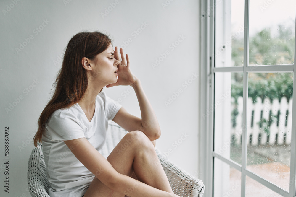 young woman sitting on the window sill young woman sitting on the window sill
