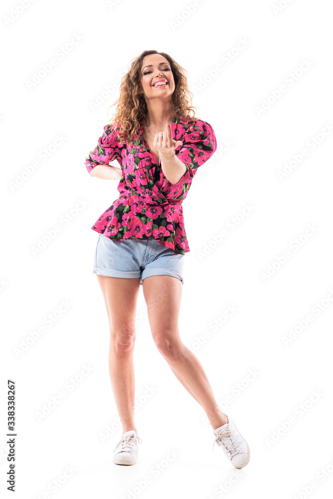 Happy seductive and provocative young woman with inviting and beckoning finger gesture looking at camera. Full body isolated on white background. Happy seductive and provocative young woman with inviting and beckoning finger gesture looking at camera. Full body isolated on white background.