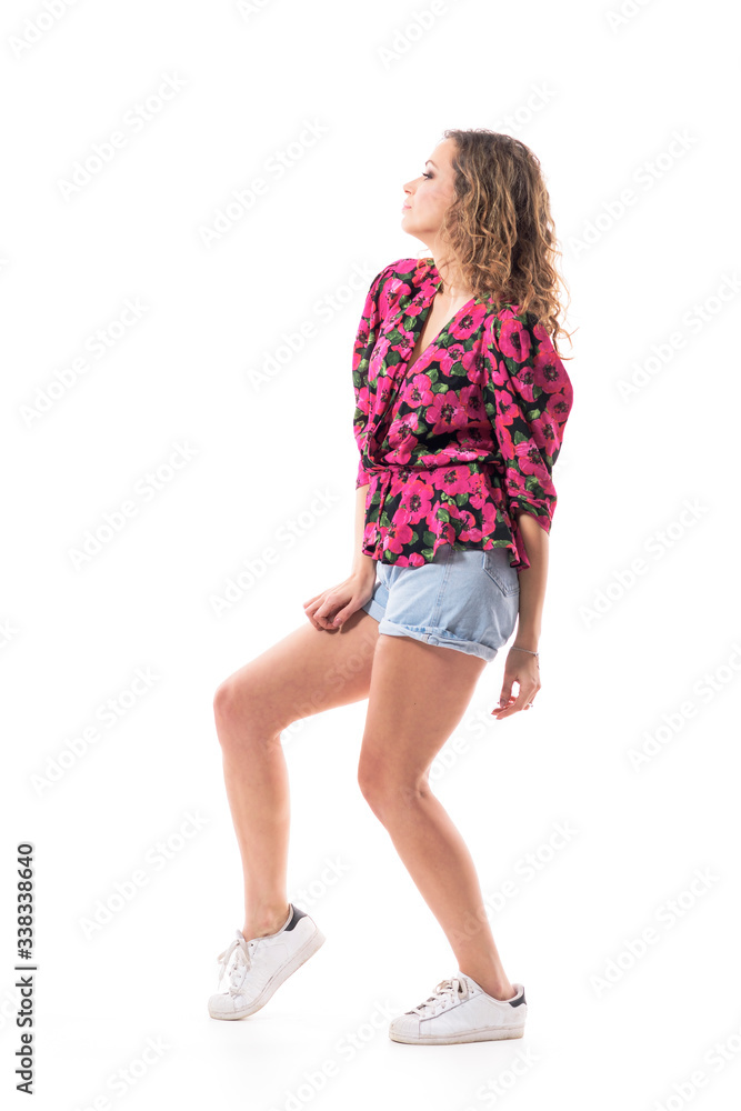 Profile view of confident stylish summer girl fashion model posing and looking away. Full body isolated on white background. Profile view of confident stylish summer girl fashion model posing and looking away. Full body isolated on white background.