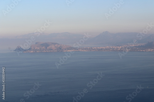 evocative image of sea coast with promontory on the background in Sicily, Italy 