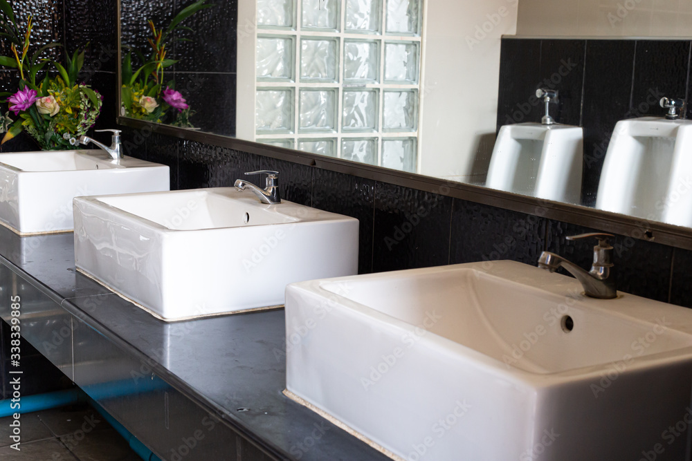 Public sinks, Handwashers for people using public toilets, Public toilets and hygiene concept. Public sinks, Handwashers for people using public toilets, Public toilets and hygiene concept.