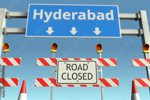 Roadblock near Hyderabad city road sign. Coronavirus disease quarantine or lockdown in India conceptual 3D rendering © Alexey Novikov