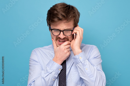 Vászonkép Caucasian funny man with glasses having a stressful conversation with his boss