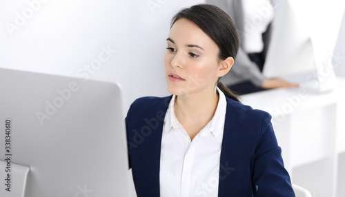 Businesswoman working with computer in office. Lawyer or accountant sitting at work, headshot. Business concept