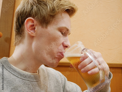 A handsome young man enjoying his beer