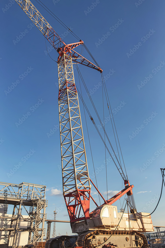 A self-propelled crawler crane stands on a construction site A self-propelled crawler crane stands on a construction site