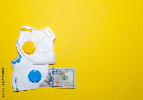 respirators and money on a yellow background