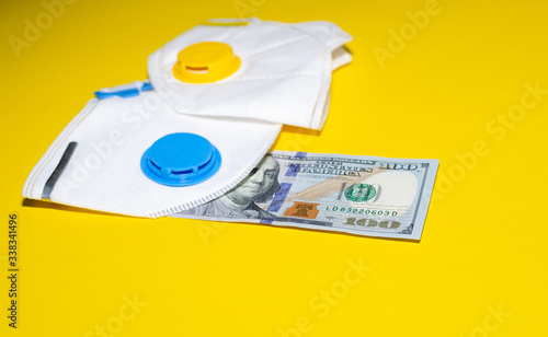 respirators and money on a yellow background
