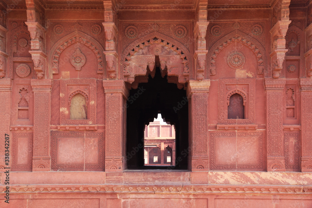 Carved indian red walls of Fatefpur Sikri Palace - UNESCO Wolrd heritage site from 16th century
