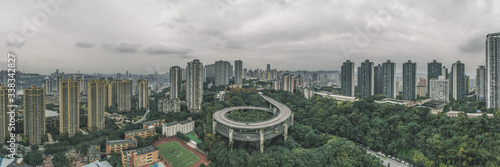 Aerial pano drone shot of particular double circle flyover road in densed residential buildings in Chongqing, southwest China photo