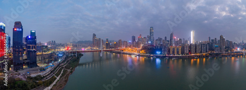 Aerial Pano drone shot of Hong Ya Dong cave by Jialing river with Qiansimen suspension bridge in Chongqing, southwest China