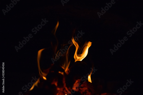 Red fiery figures on black background photo