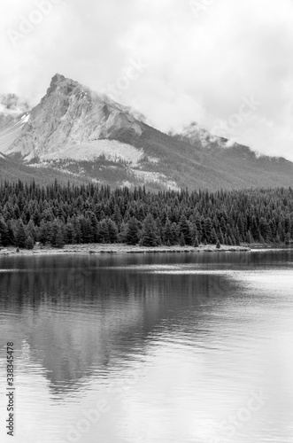 Black and White tall mountains behind lake in British Columbia, Canada