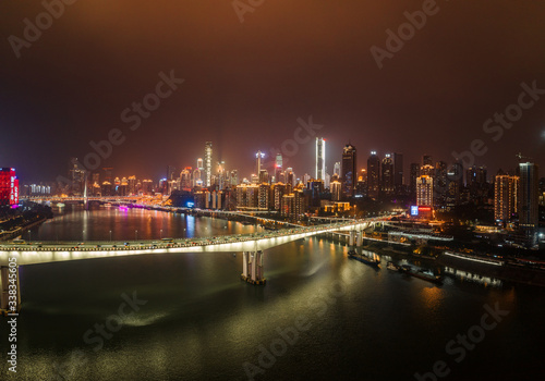 Aerial night view of Hong Ya Dong cave with Huanghuayuan and Qiansimen Bridge in Chongqing, southwest China